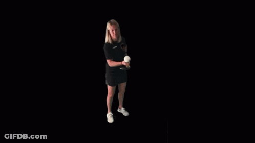 A Woman Is Holding A Tennis Racquet And A Tennis Ball . GIF