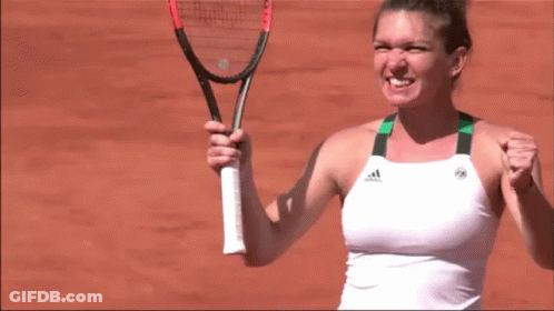 A Woman Is Holding A Tennis Racquet And Wearing An Adidas Shirt GIF