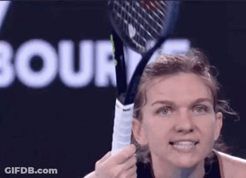 A Woman Is Holding A Tennis Racquet In Front Of A Court Sign GIF