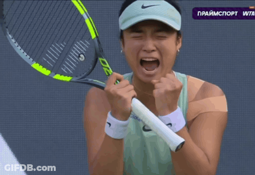A Woman Is Holding A Tennis Racquet In Front Of A Screen That Says Primesport Wta GIF