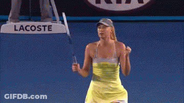 A Woman Is Holding A Tennis Racquet In Front Of A Sign That Says Lacoste GIF
