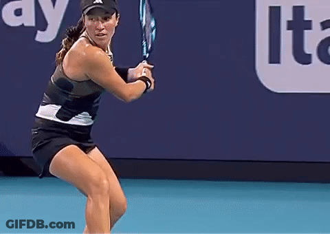 A Woman Is Holding A Tennis Racquet On A Court In Front Of An Advertisement For Lte GIF