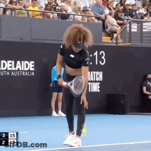 A Woman Is Holding A Tennis Racquet On A Tennis Court With A Sign That Says Adelaide On It GIF