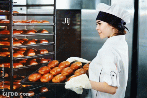 A Woman Is Holding A Tray Of Bread In Front Of A Rack Of Bread And The Word Jij Is On The Bottom GIF
