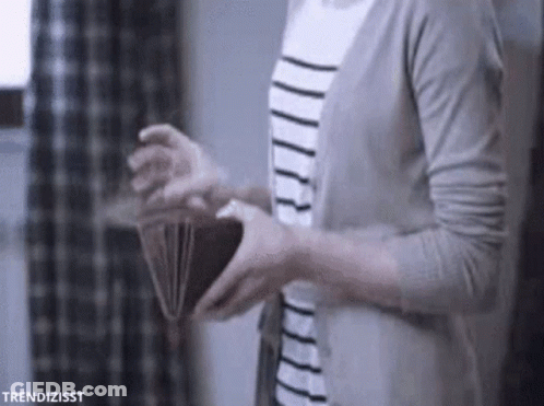 A Woman Is Holding An Open Wallet In Her Hands . GIF