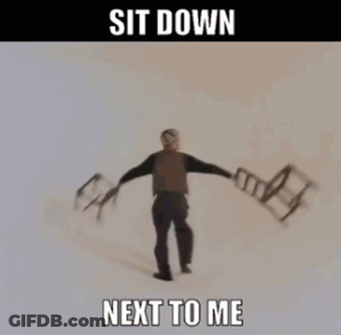 A Woman Is Holding Chairs In Her Hands With The Words Sit Down Next To Me GIF