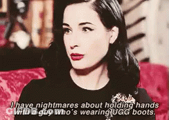 A Woman Is Holding Hands With A Man Who Is Wearing Ugg Boots GIF