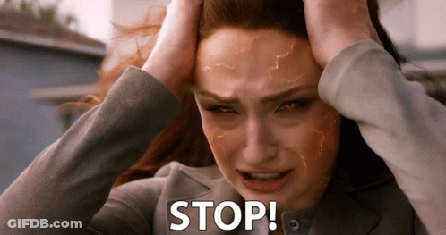 A Woman Is Holding Her Head With The Word Stop Written On It GIF