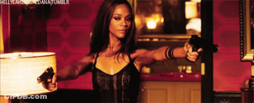 A Woman Is Holding Two Guns In Front Of A Lamp And The Words Hellyeah Dana Tumblr Are Visible GIF