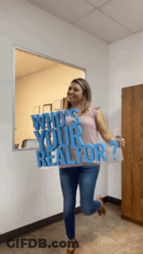 A Woman Is Holding Up A Sign That Says Who 'S Your Realtor GIF