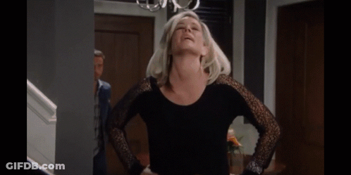 A Woman Is Hugging A Man With A Ring On Her Finger GIF