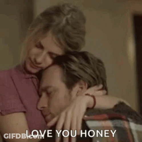 A Woman Is Hugging A Man With The Words `` Love You Honey '' Written On It . GIF