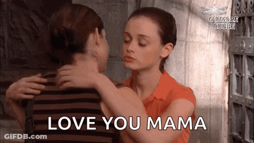 A Woman Is Hugging A Man With The Words `` Love You Mama '' Written On The Bottom . GIF