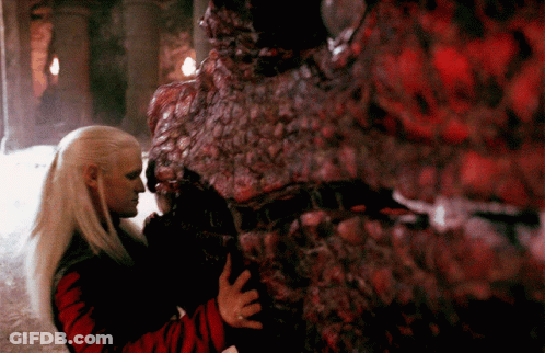 A Woman Is Hugging A Monster That Is Covered In Red Spots GIF