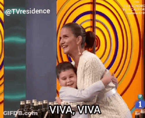 A Woman Is Hugging A Young Boy With The Words Viva Viva Written On The Bottom GIF