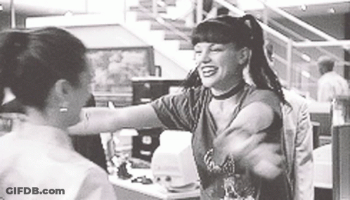 A Woman Is Hugging Another Woman In A Black And White Photo . GIF