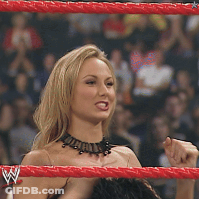 A Woman Is In A Wrestling Ring With A W Logo On Her Arm GIF