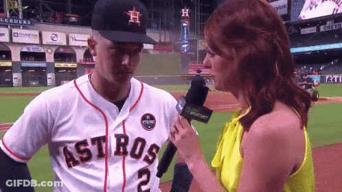 A Woman Is Interviewing A Baseball Player Who Is Wearing A Jersey That Says Astros GIF