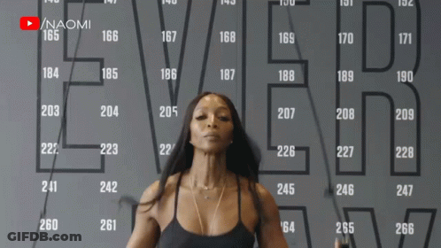 A Woman Is Jumping A Jump Rope In Front Of A Wall That Says Ever On It GIF