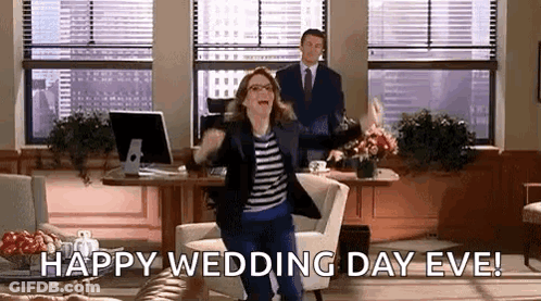 A Woman Is Jumping In The Air In An Office While A Man Stands Behind Her And Says Happy Wedding Day Eve . GIF