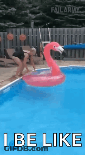 A Woman Is Jumping Into A Pool With An Inflatable Flamingo . GIF