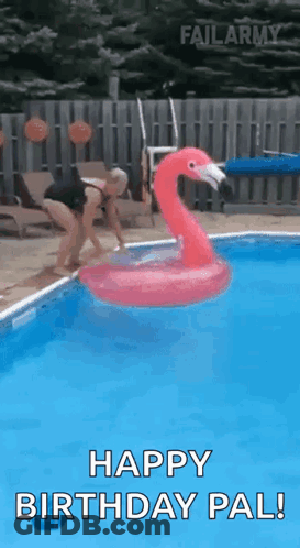 A Woman Is Jumping Into A Swimming Pool With A Flamingo Float . GIF
