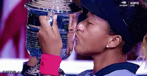 A Woman Is Kissing A Trophy That Says Us Open On It GIF