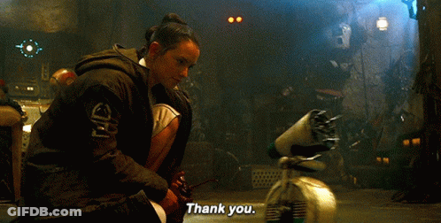 A Woman Is Kneeling Down In Front Of A Robot And Saying Thank You GIF