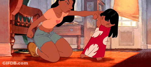 A Woman Is Kneeling Down Next To A Little Girl . GIF