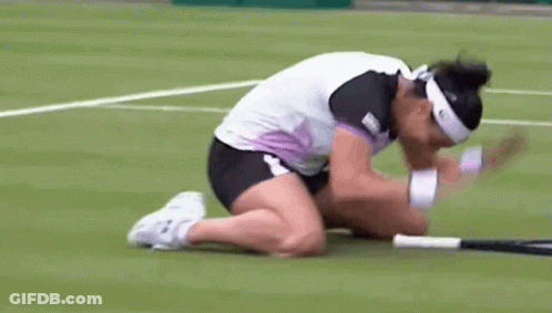 A Woman Is Kneeling Down On A Tennis Court With Her Head On A Tennis Racquet GIF