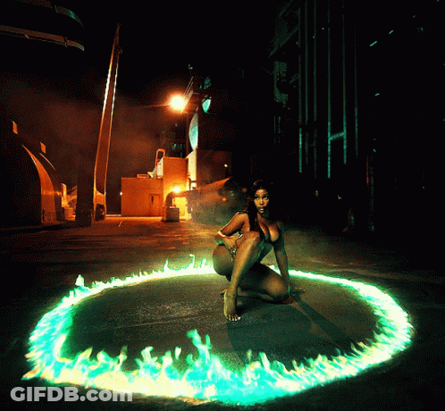 A Woman Is Kneeling In A Circle Of Green Flames GIF