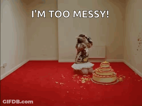 A Woman Is Kneeling In Front Of A Cake In A Room . GIF