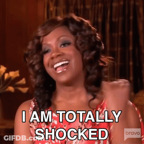 A Woman Is Laughing And Saying " I Am Totally Shocked " . GIF