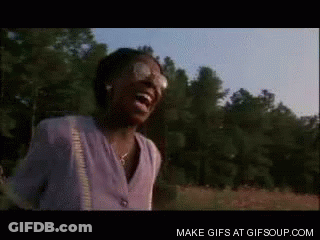 A Woman Is Laughing In A Field With Trees In The Background And The Words Make Gifs At Gifsoup.com GIF