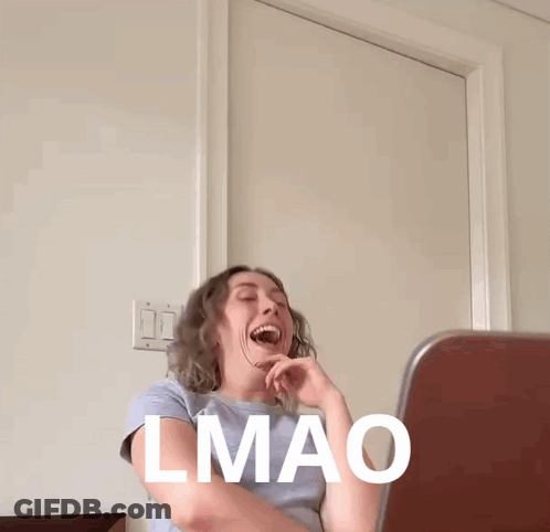 A Woman Is Laughing In Front Of A Laptop With The Word Lmao Written On Her Face GIF