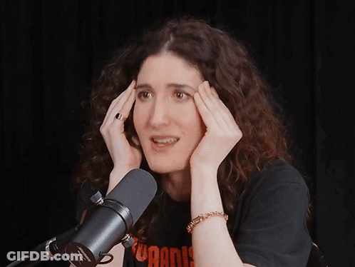 A Woman Is Laughing In Front Of A Microphone That Says ' Sven ' On It GIF