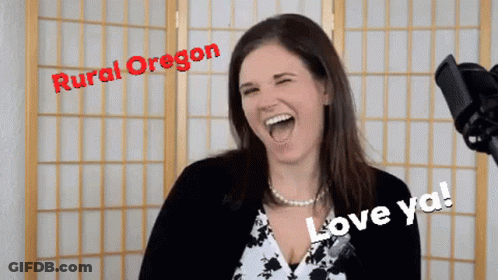 A Woman Is Laughing In Front Of A Microphone With Rural Oregon Written On The Top GIF