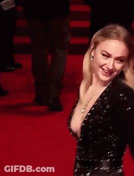 A Woman Is Laughing On A Red Carpet With Her Mouth Open GIF
