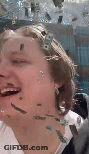 A Woman Is Laughing While Money Falls On Her Face GIF