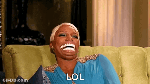 A Woman Is Laughing While Sitting On A Couch And Saying Lol . GIF