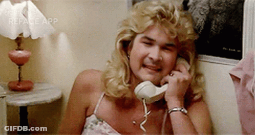 A Woman Is Laughing While Talking On A Phone . GIF