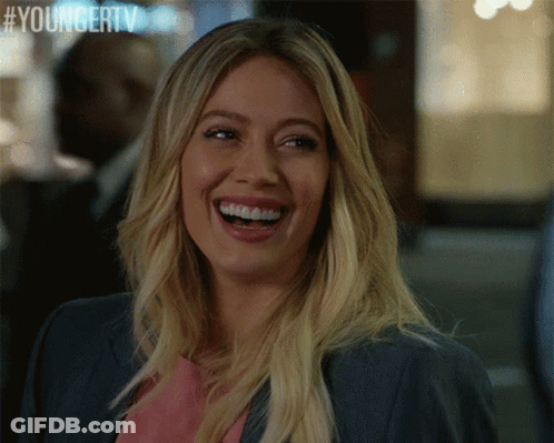 A Woman Is Laughing With A Youngertv Logo In The Corner GIF