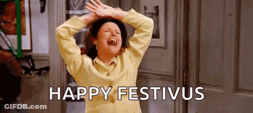 A Woman Is Laughing With Her Hands In The Air And The Words `` Happy Festivus '' Written On The Bottom . GIF