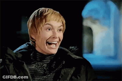 A Woman Is Laughing With Her Mouth Open And Wearing A Black Jacket . GIF