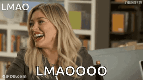 A Woman Is Laughing With The Words Lmao Lmaoooo Behind Her GIF