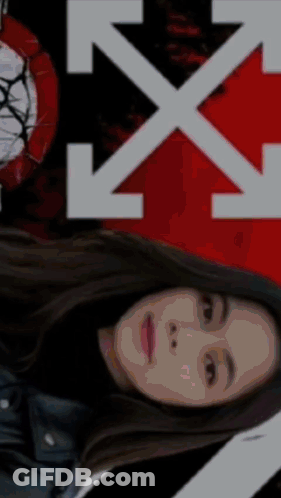 A Woman Is Laying Down In Front Of A White X On A Red And Black Background GIF