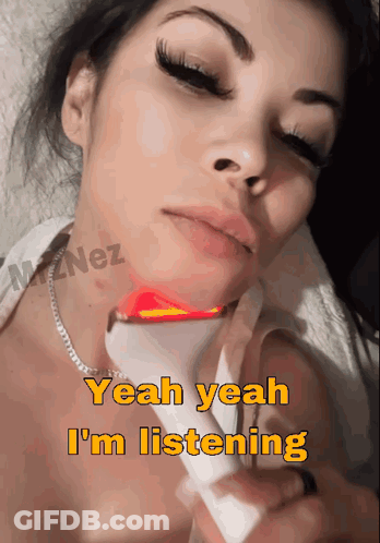 A Woman Is Laying Down With A Device On Her Neck And The Words Yeah Yeah I 'M Listening Above Her GIF