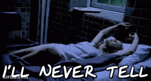 A Woman Is Laying In A Bed With The Words " I 'Ll Never Tell " On The Bottom GIF