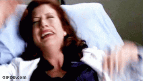 Woman Lying In Hospital Bed With Man Holding Her GIF