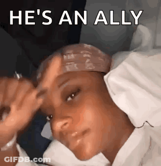 A Woman Is Laying In Bed With A Bandana On Her Head And The Words `` He 'S An Ally '' Above Her . GIF